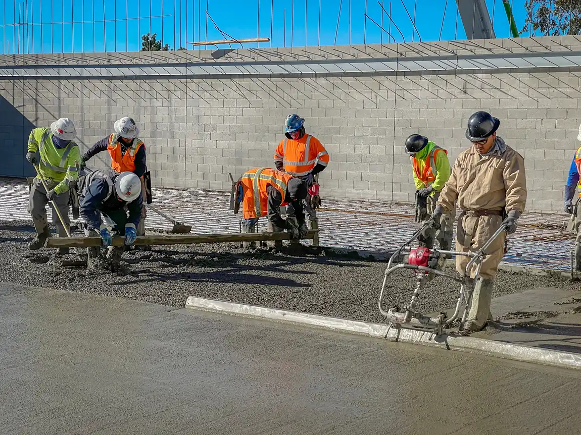Crew pouring a commercial concrete slab