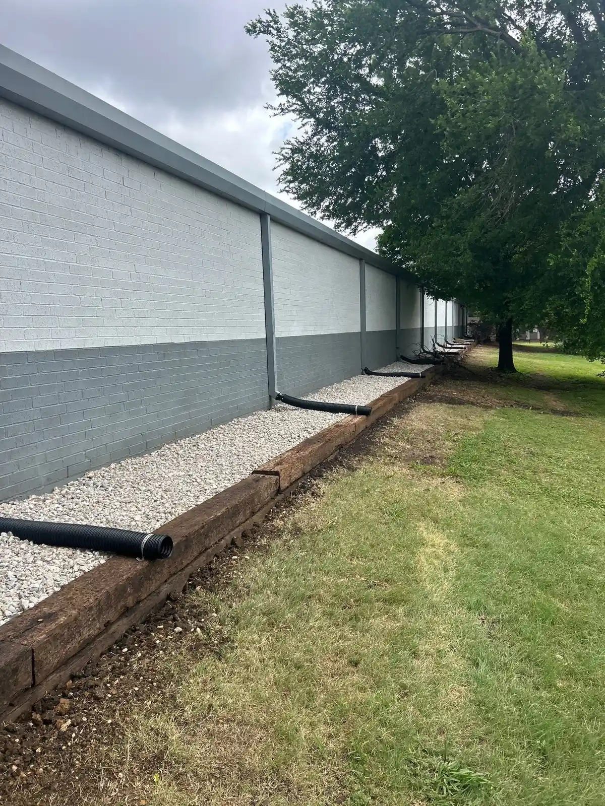 Gravel french drain line installed along a commercial building