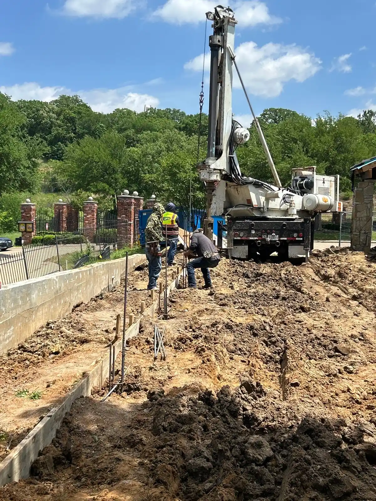 Drilling rig and crew installing commercial foundation piers
