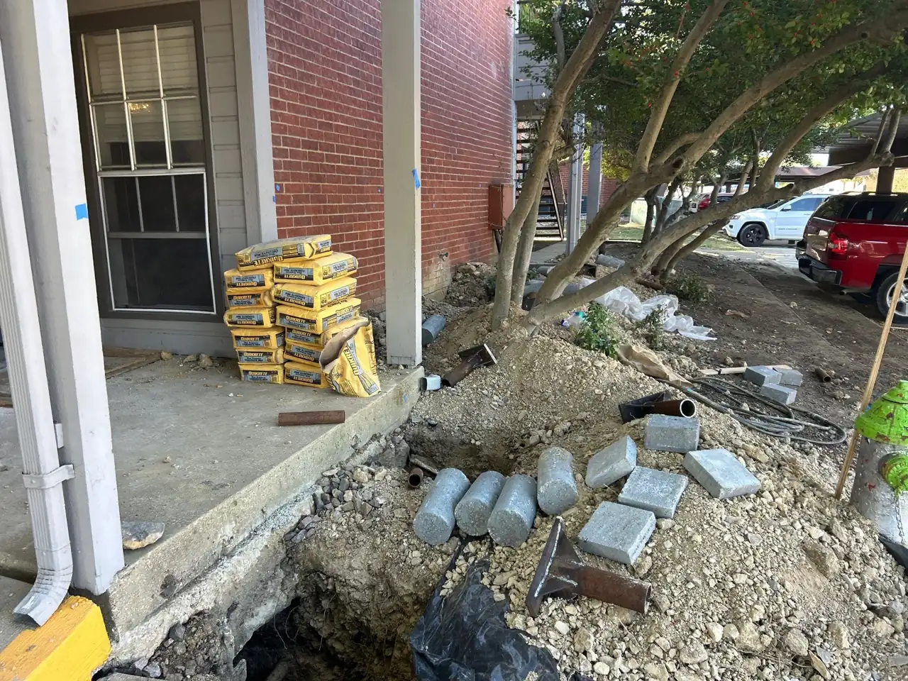 Pier materials staged at an occupied multifamily property