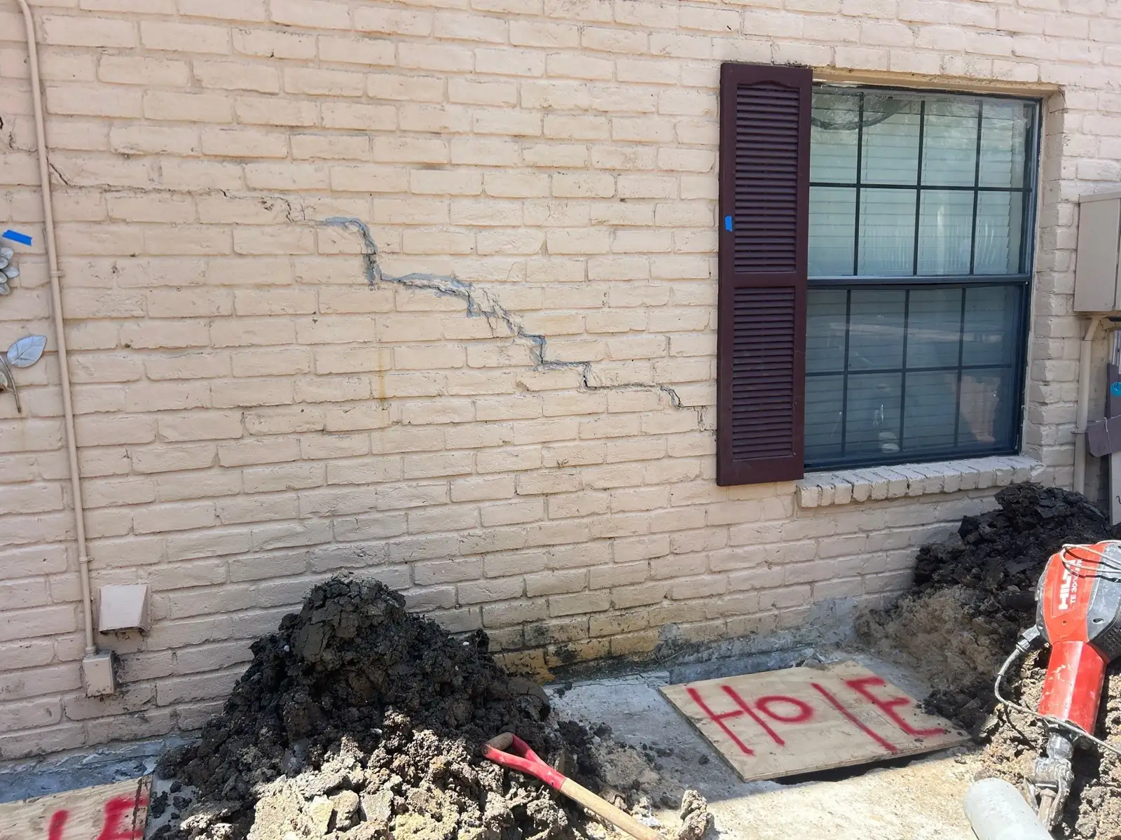 Settlement cracking in a multifamily masonry wall before repair