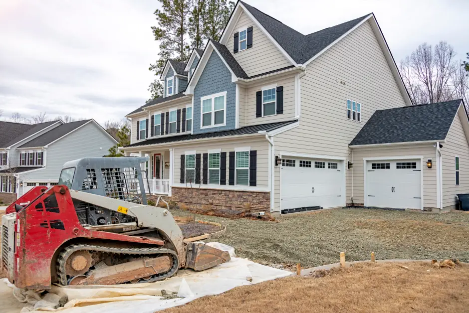 Skid steer performing foundation work at a new construction home