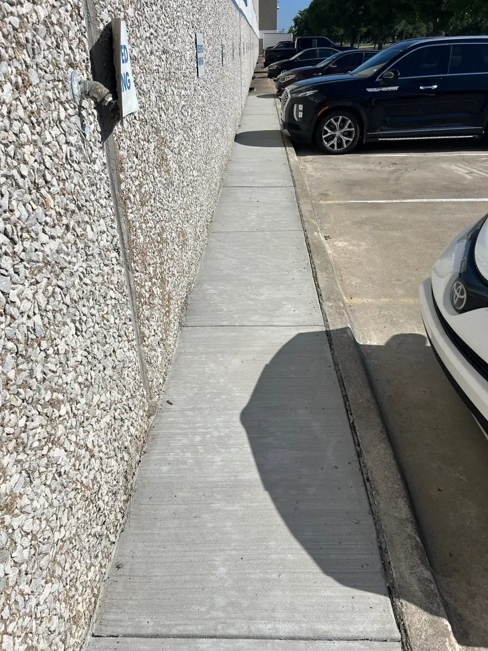 Repaired sidewalk section along a commercial corridor