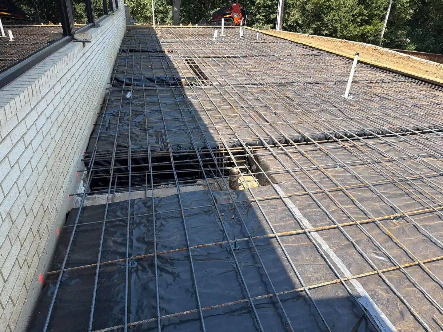 Rebar mat over vapor barrier prepared for a new construction foundation pour