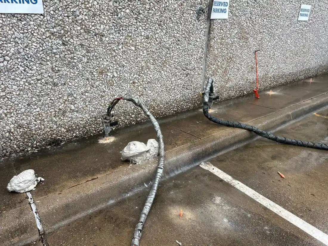 Polyurethane injection hoses and ports along the building base at the industrial facility