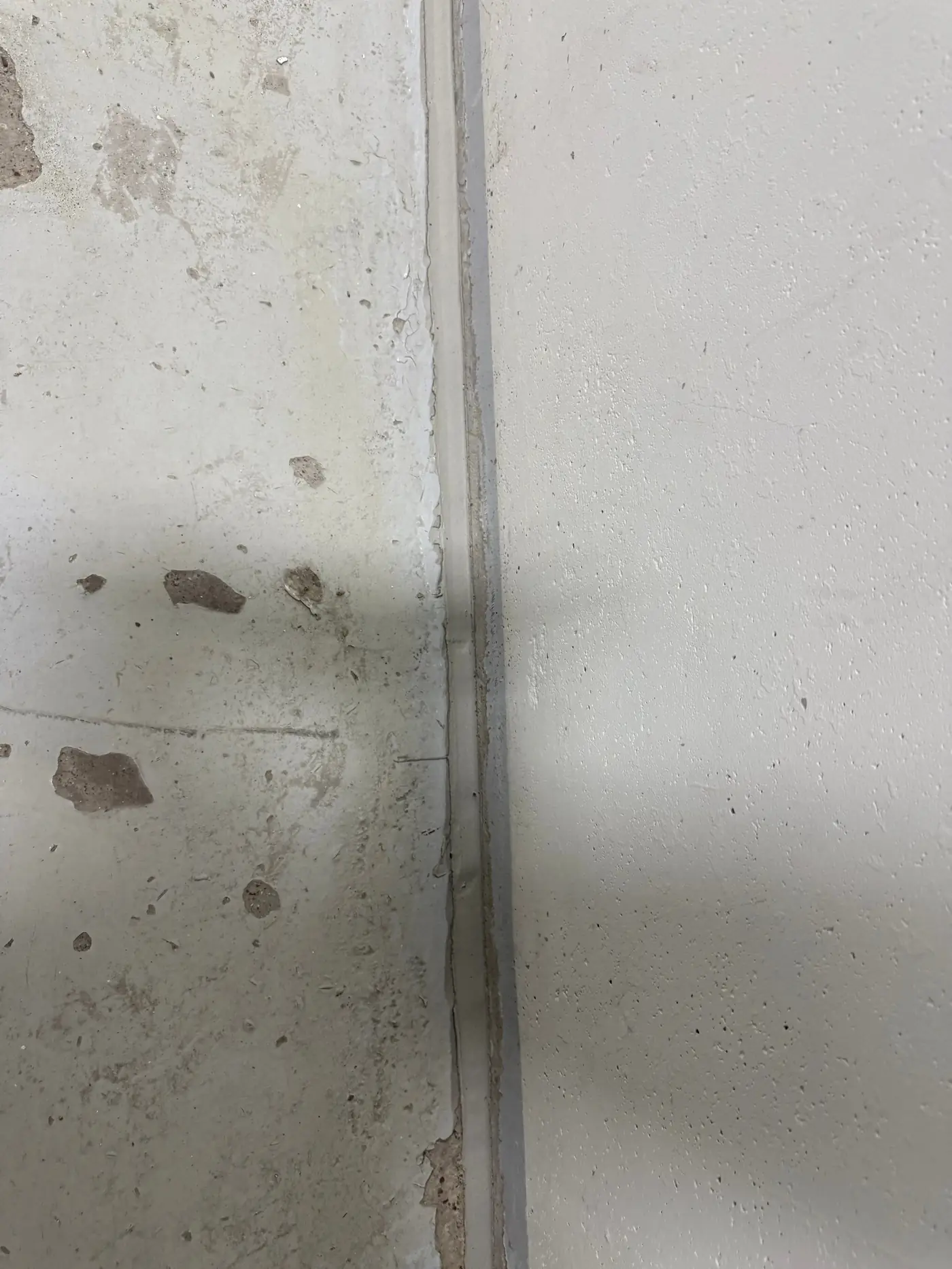 Sealed joint between two tilt-wall concrete panels after repair