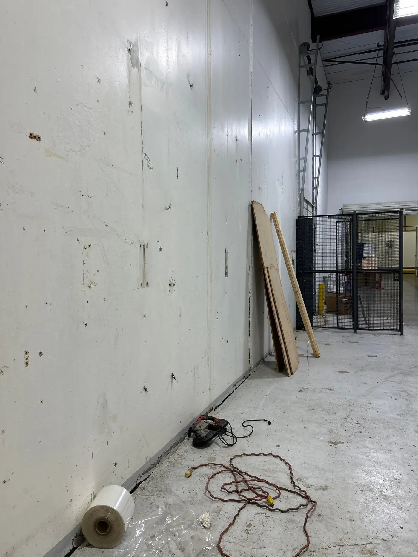 Tilt-wall panel wall and slab edge inside a warehouse during repair work