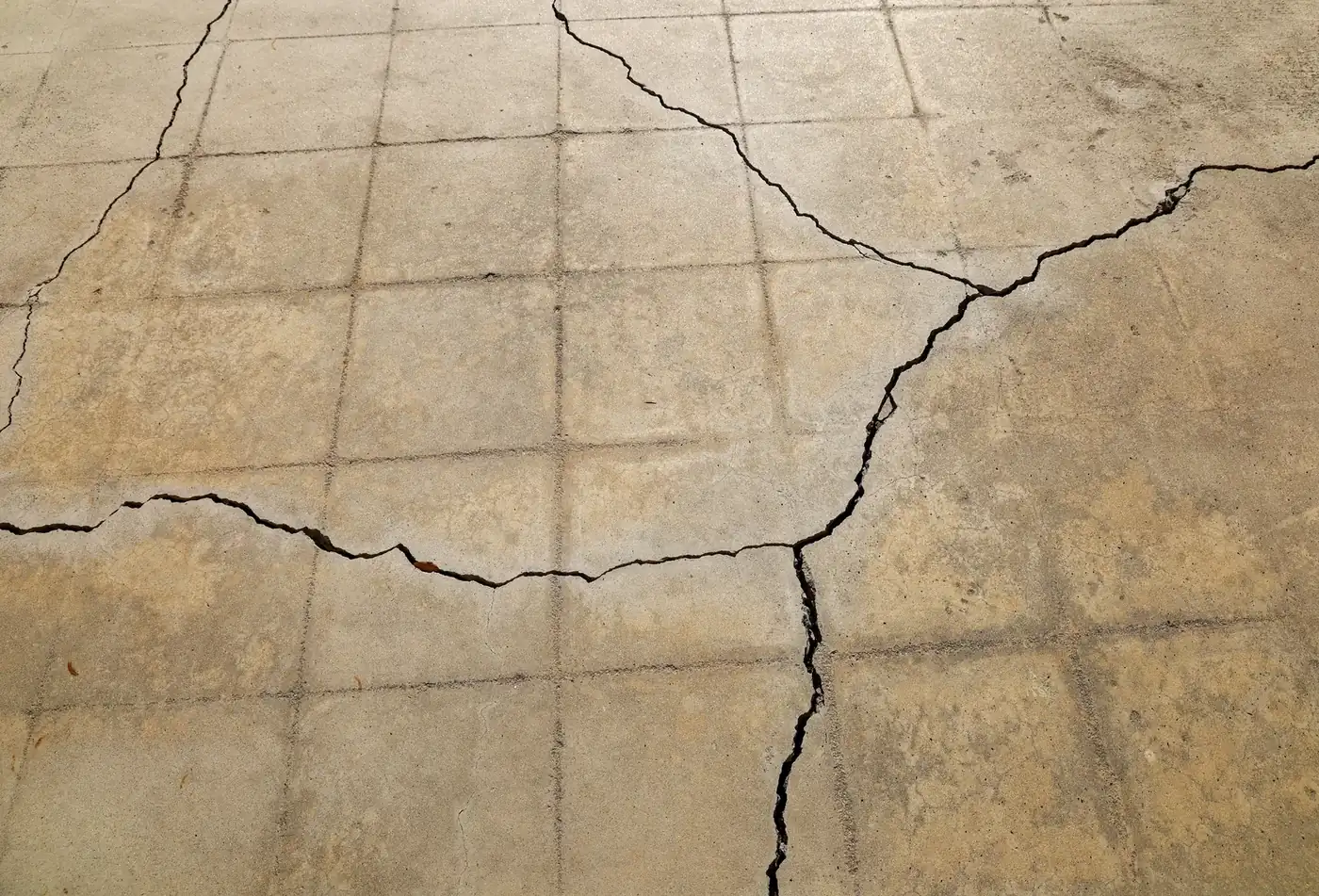 Concrete slab showing settlement cracking, illustrative condition photo